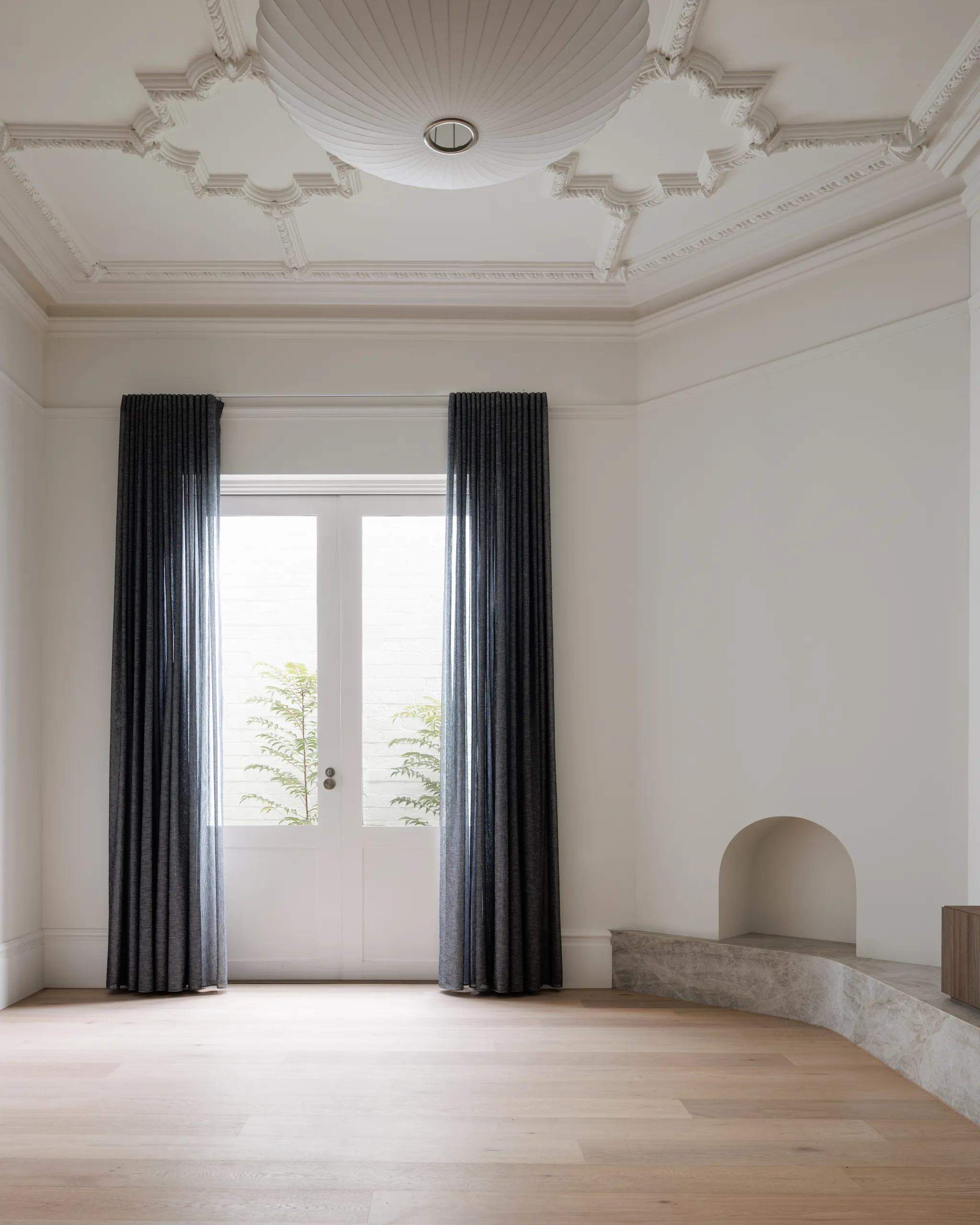 Restored front room with decorative ceiling, original proportions and garden outlook