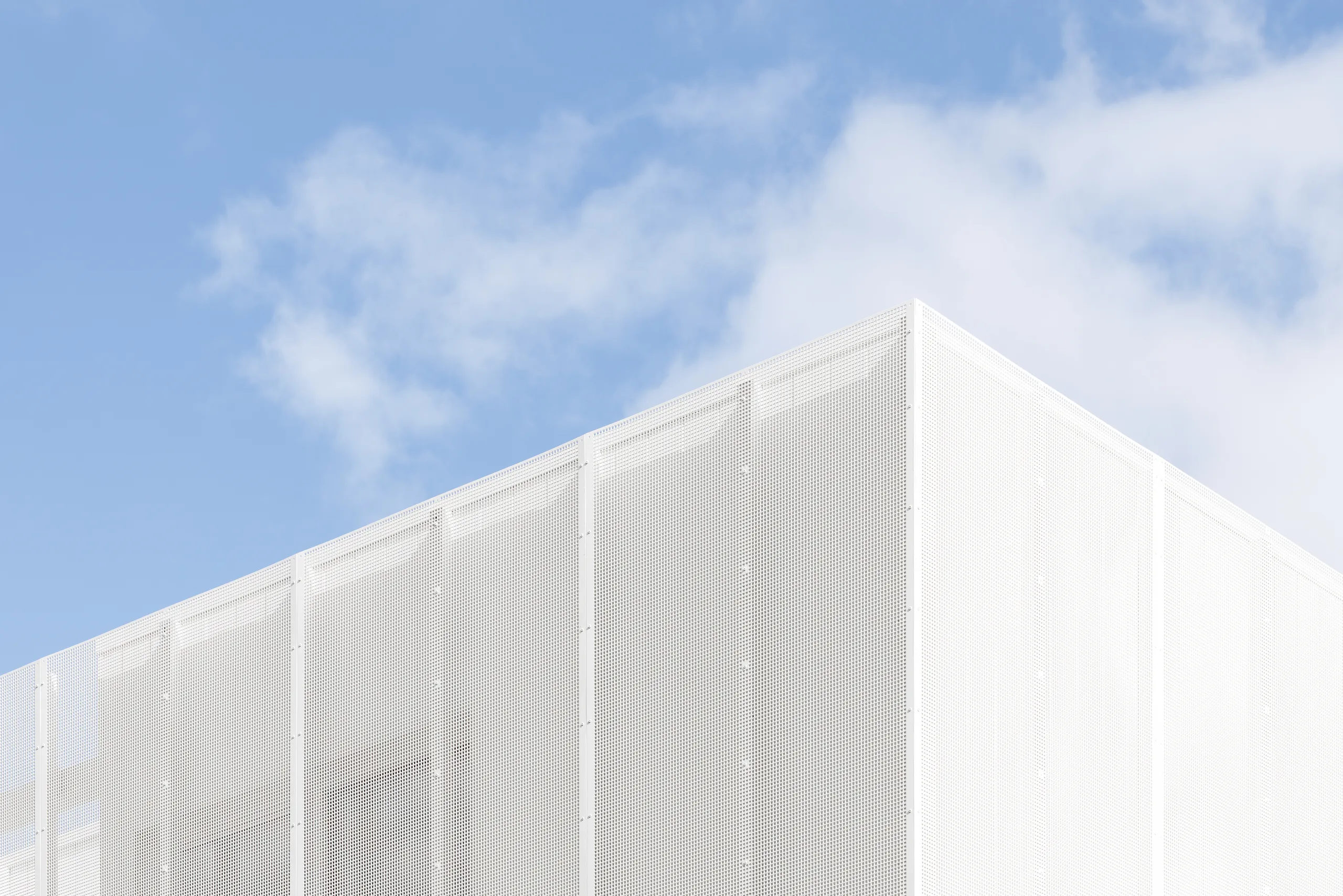 Corner of the perforated screen facade against open sky